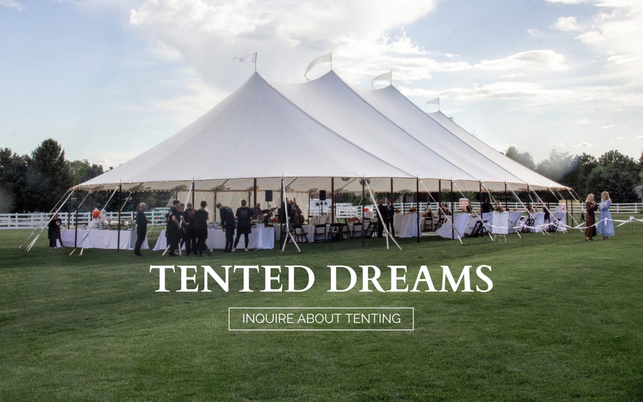 Party being held under large framed tents