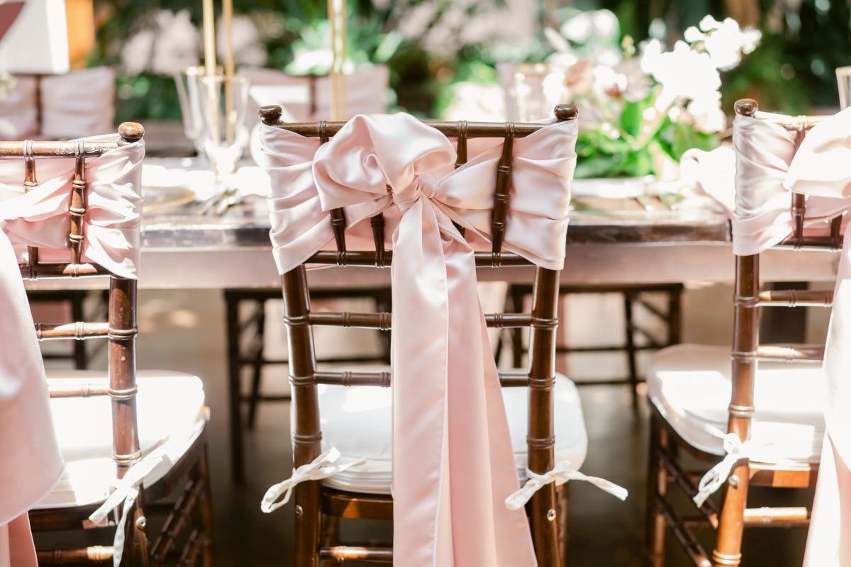 Wedding chairs with pink linens tied on the backs