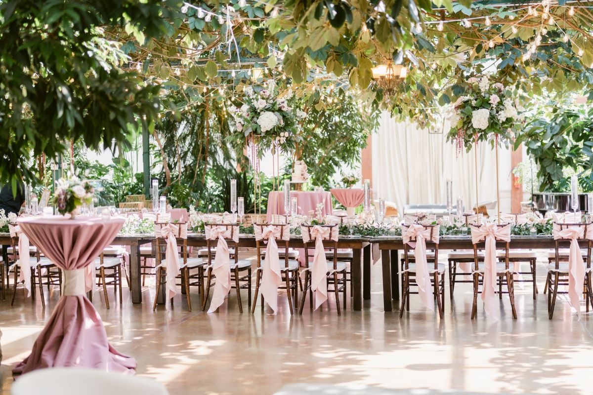 Indoor wedding table arrangement with foux trees and plants