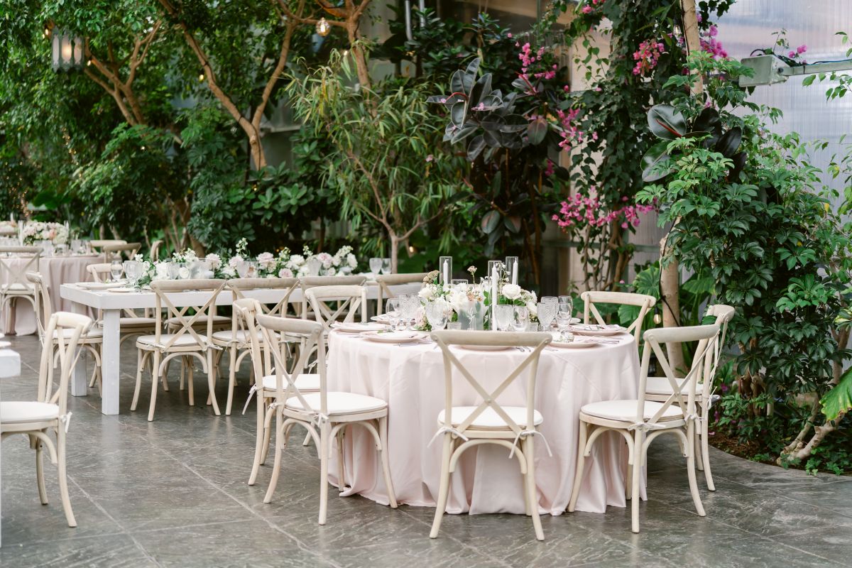 Indoor tables for weddings with faux trees and plants