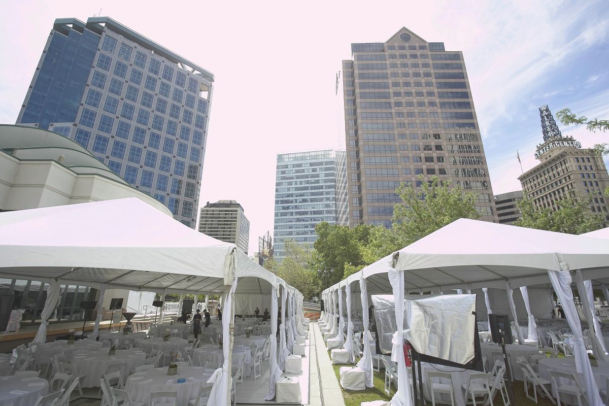 skyline with white event tent and chairs