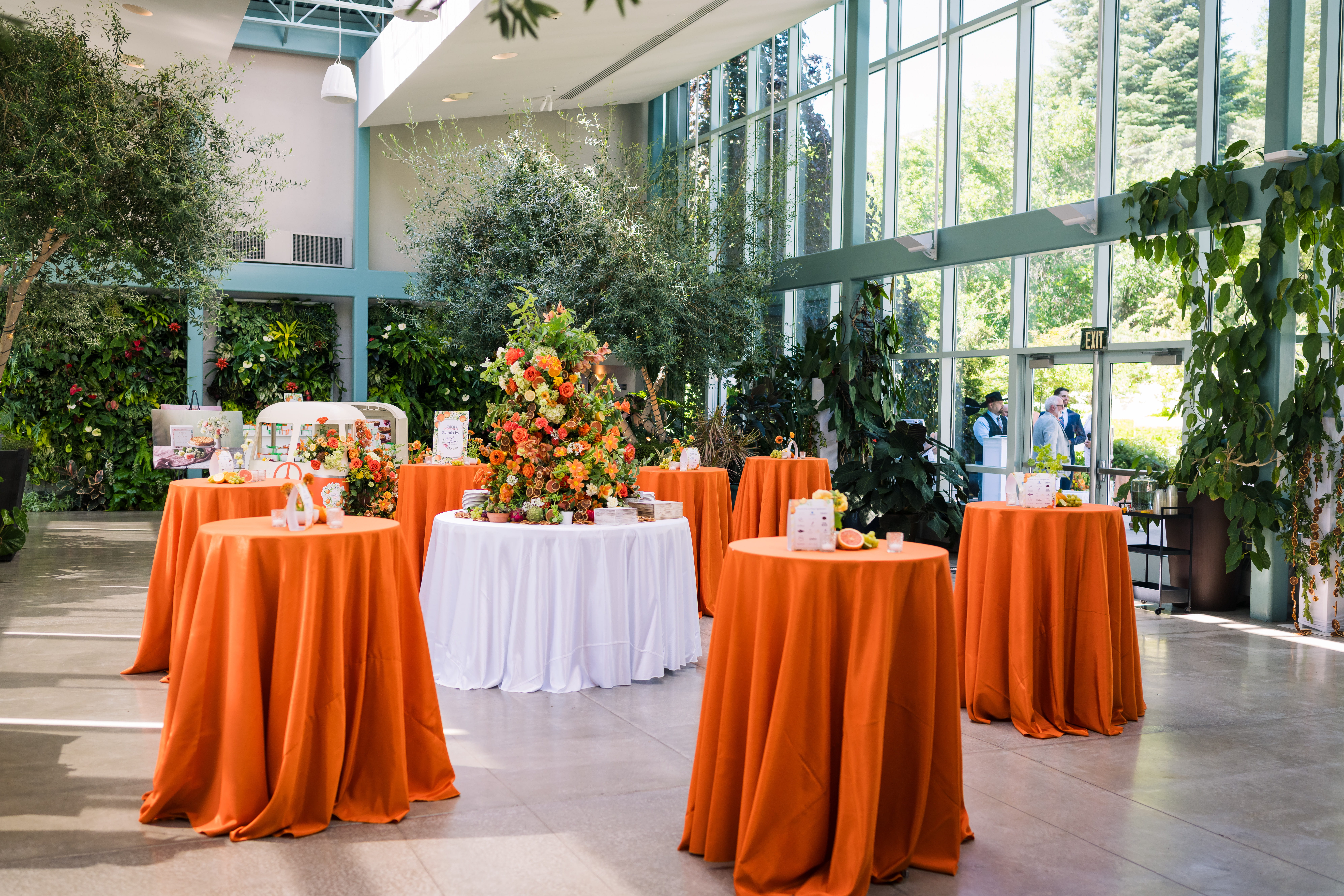 orange tables and floral arrangements with plants